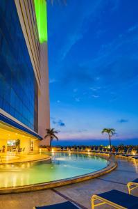 a swimming pool in front of a building at night at Hotel Almirante Cartagena Colombia in Cartagena de Indias