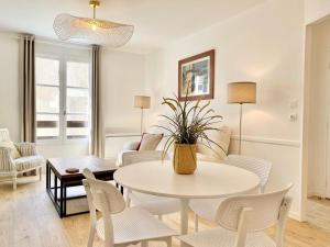 a living room with a table and chairs at Appartement élégant avec vue sur le port in Saint-Martin-de-Ré