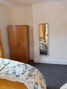 um quarto com uma cama, uma cómoda e um espelho em The Cosy 2 bedroom flat, sleeps 6 em Hebburn-on-Tyne