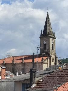 an old building with a clock tower on top of it at Apartamento TerradeAugas3 in Caldas de Reis