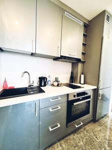 a kitchen with a sink and a stove top oven at Apartament nad Pisą in Pisz
