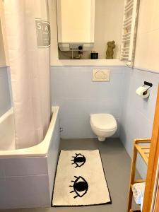 a bathroom with a toilet and a shower and a rug at Old Town Apartment in Gdańsk