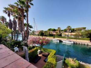 a view of a river with palm trees and a boat at Maralis Portorosa in Furnari +16 photos
