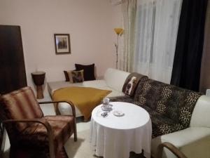 a living room with a couch and a table at KOKOPEPINO in Litomyšl