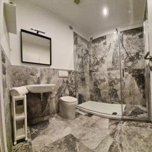 a bathroom with a toilet and a sink and a shower at 180Passi B&B in Lido Marini