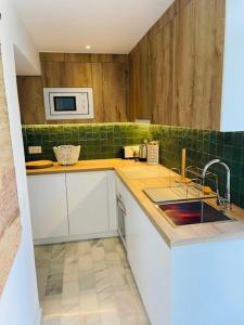 a kitchen with a sink and a microwave at Lovely studio in Marbella