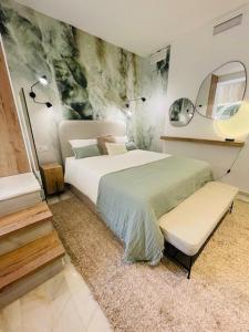 1 dormitorio con 1 cama grande y espejo en Lovely studio, en Marbella
