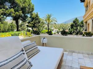 a white bed sitting on top of a balcony at Lovely studio in Marbella