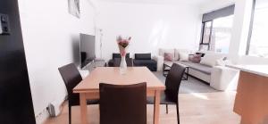 a table with chairs and a vase of flowers on it in a room at Reykjavik Antique Rentals in Reykjavík +32 photos