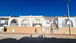 a brick building with arched windows on a street at Cozy house in Mazarrón, city view in Mazarrón