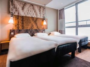 Een bed of bedden in een kamer bij Hotel ibis Den Haag City Centre