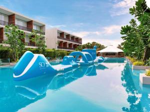 a pool at a resort with a water slide at SO/ Sofitel Hua Hin in Cha Am