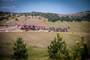 a group of houses on a hill in a field at The Crown Lodge in Zlatibor
