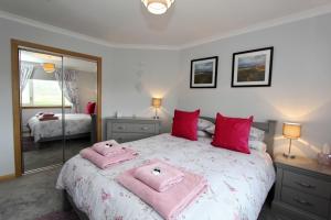 A bed or beds in a room at Machair Cottage