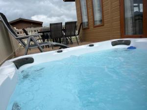 a hot tub on the back of a house at Kingfisher Lodge with Hot Tub in Malton