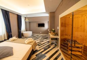 a hotel room with a bed and a bath tub at Hotel Cala Moresca in Bacoli