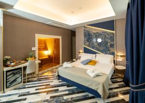 a hotel room with a bed and a desk at Hotel Cala Moresca in Bacoli