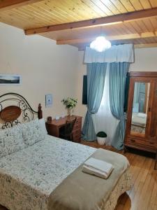 a bedroom with a bed and a desk and a window at Casa Licerio in Samos
