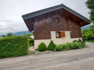 a small house with a brown roof on a road at Chalet Morillon Village, 3 pièces, 7 personnes - FR-1-642-42 in Morillon