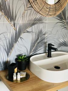 a bathroom with a white sink and a plant at A casa di Alberta B&B Relais in Rotondella +34 photos