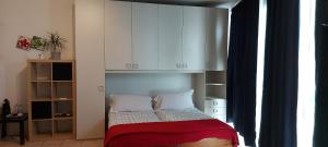 a small bedroom with a bed with white cabinets at Feel Like Home In Milan in Milan