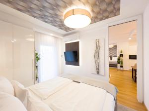 Postel nebo postele na pokoji v ubytování VIVA Apartments