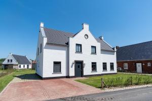 a white house with a black roof at Parc Maasresidence Thorn in Thorn +71 photos