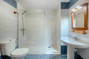 a bathroom with a toilet and a sink at Sea You Apartamentos Valencia Port Saplaya in Port Saplaya