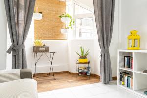 a bedroom with gray curtains and a window at YOLO House - Corralejo in Corralejo