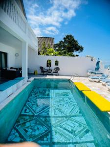 a pool with a view of a house at Hotel Tramonto in Chakvi