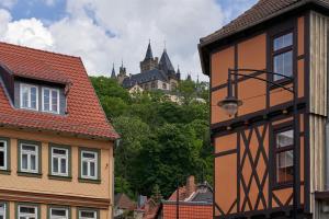 miasto z budynkami i zamkiem w tle w obiekcie Hotel Schlossblick w mieście Wernigerode