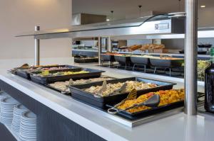 a buffet line with many different types of food at Las Palmeras Affiliated by FERGUS in Fuengirola