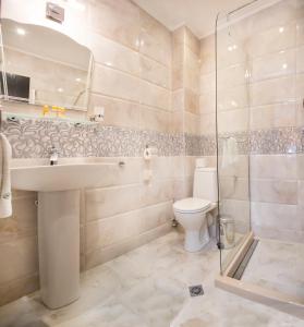 a bathroom with a toilet and a sink and a shower at Boutique Hotel VSK Kentavar in Dryanovo