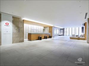 an empty lobby of a building with a reception desk at Daiwa Roynet Hotel Sendai Nishiguchi PREMIER in Sendai