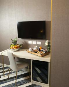 a room with a table with food on it at Hotel Cala Moresca in Bacoli