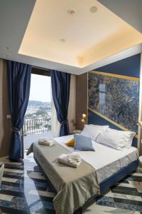 a bedroom with a bed and a large window at Hotel Cala Moresca in Bacoli