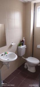 a bathroom with a toilet and a sink at D'Zara Homestay in Sepang