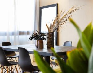 a dining room table with plants and a mirror at Hotel Constellation in Lido di Savio