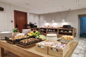 a kitchen with a table filled with lots of food at Hotel Saurat in Espot