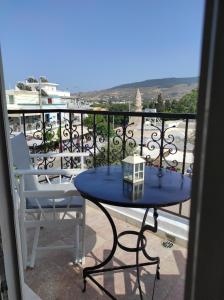 a blue table and two chairs on a balcony at Komfort Appartment in Kos Town