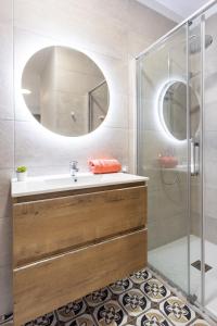 a bathroom with a sink and a shower with a mirror at Punto Fijo - 3 minutes walking to Beach San Telmo in Puerto de la Cruz