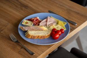 a blue plate of food on a wooden table at Moro Inn in Korčula