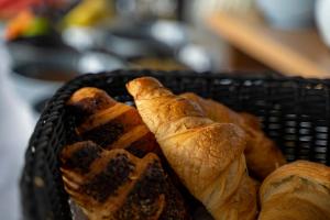 a basket with bread and croissants in it at Moro Inn in Korčula