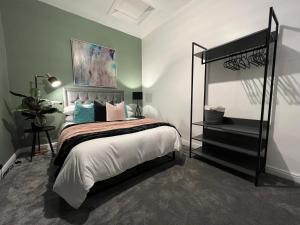 a bedroom with a bed with a black bed frame at City Haven Stylish Home in Manchester