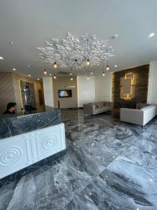 a lobby with a marble floor and a chandelier at Green Garden City Luxury Apartments in Alanya +82 photos