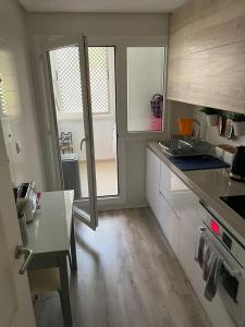 a kitchen with a sink and a stove top oven at La Torre Golf Resort, Mero, Torre-Pacheco, Murcia in Murcia