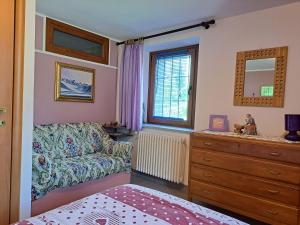 a living room with a couch and a dresser at La maison de Chantal in Fenis