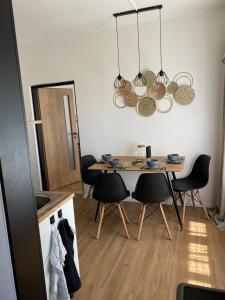 a dining room with a table and chairs at Panda apartmán Frýdštejn in Frýdštejn