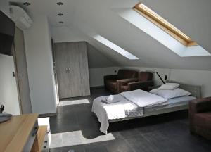 a bedroom with a bed and a skylight at Reza in Bełchatów