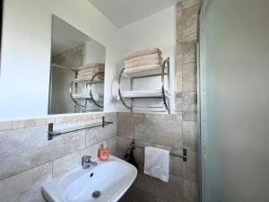 a bathroom with a sink and a mirror at Casa Cenţiu in Bran +67 photos